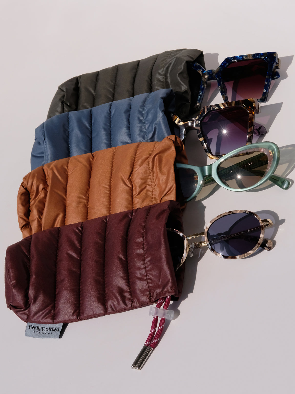 soft eyewear case, optical accessories, sunglass pouch sleeve, available in four colors, made from recycled materials, drawstring pouch for accessories, keys, makeup, phone, wallet, camera and more, travel essentials, luxury optical extras, unisex, organize items, protect from scratches and dust, outdoor activities