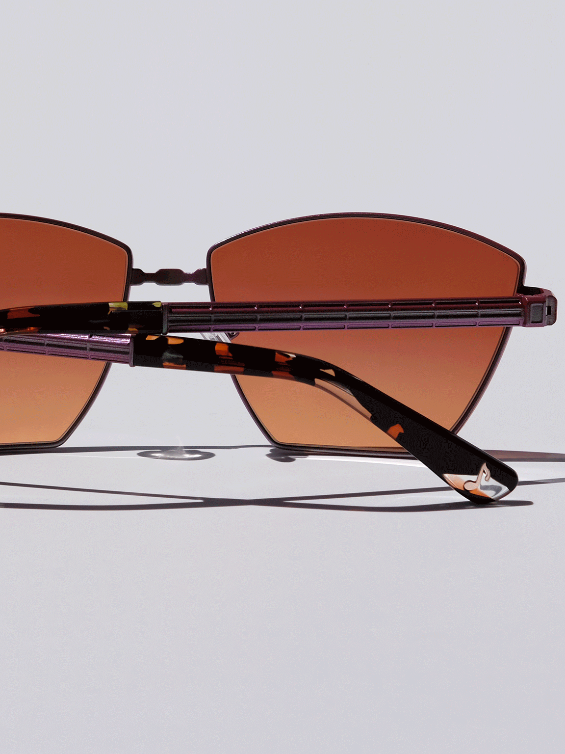 Lightweight titanium glasses, strong titanium sunglasses, sunglasses & optical, luxury eyewear, mazzucchelli italian acetate, made in japan, mythology, eyewear designer, woman owned small business, summer accessories, chic style, celebrity style, aviator glasses, d-frame eyewear, cat eye sunglasses, art deco, geometric art, red glasses, maroon sunglasses