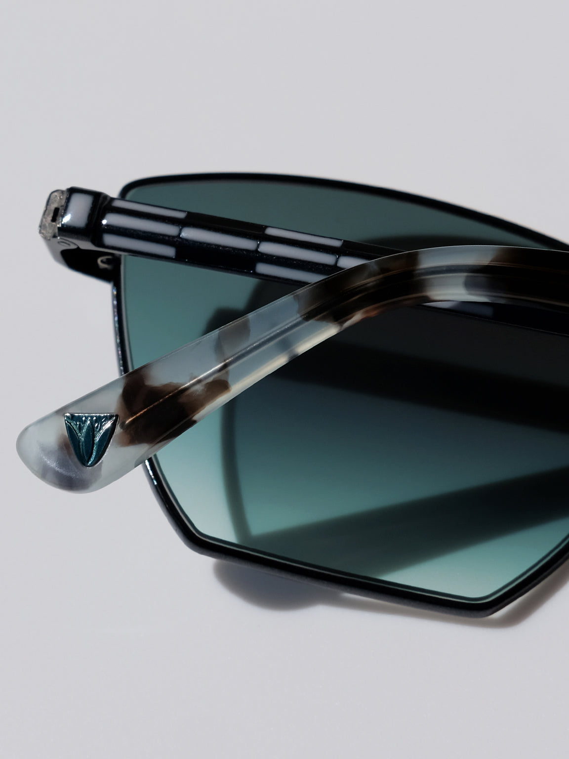 Lightweight titanium glasses, strong titanium sunglasses, sunglasses & optical, luxury eyewear, mazzucchelli italian acetate, made in japan, mythology, eyewear designer, woman owned small business, summer accessories, chic style, celebrity style, aviator glasses, d-frame eyewear, cat eye sunglasses, art deco, geometric art, black glasses, enamel detail