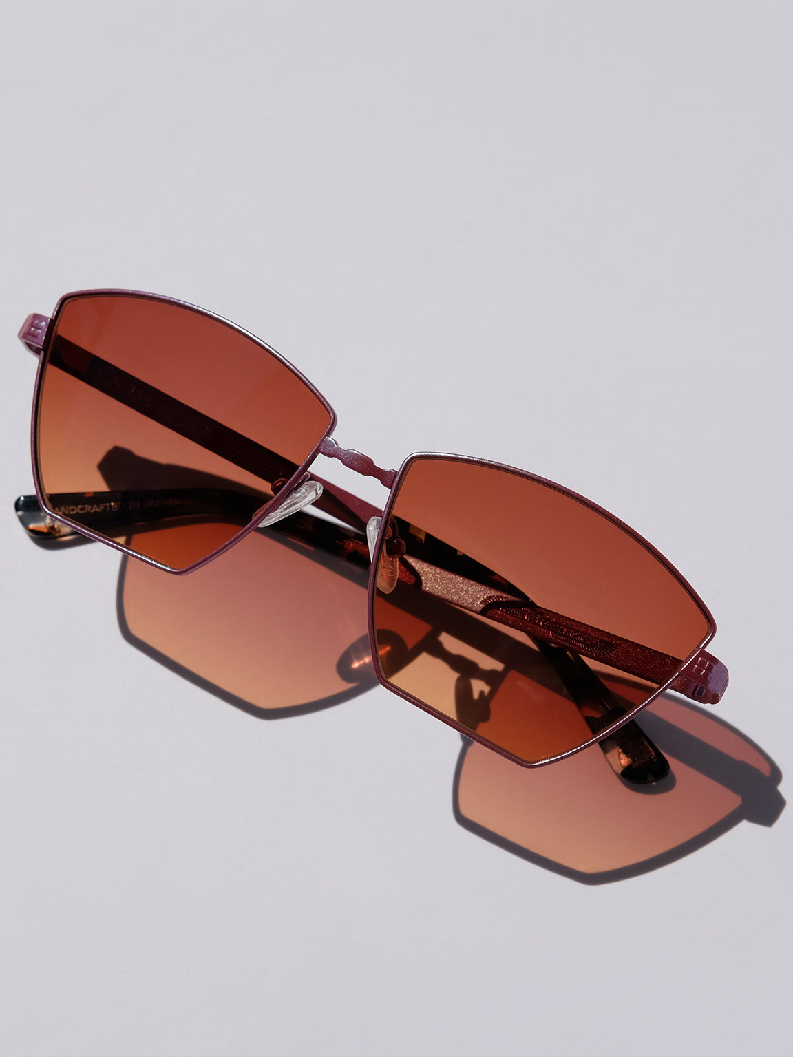 Lightweight titanium glasses, strong titanium sunglasses, sunglasses & optical, luxury eyewear, mazzucchelli italian acetate, made in japan, mythology, eyewear designer, woman owned small business, summer accessories, chic style, celebrity style, aviator glasses, d-frame eyewear, cat eye sunglasses, art deco, geometric art, red glasses, maroon sunglasses