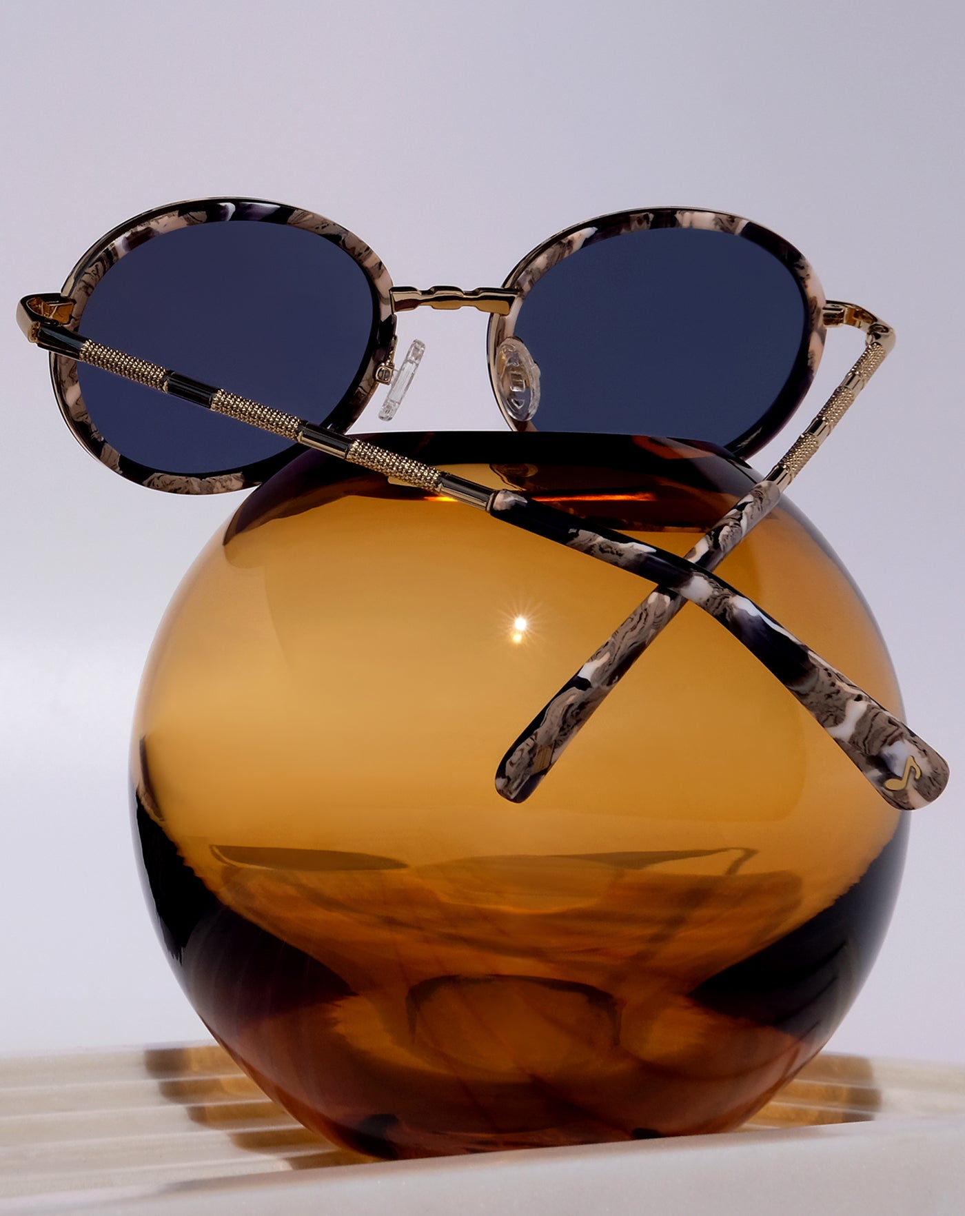 GOLD CLASSIC UNISEX OVAL SUNGLASSES, GOLD METAL DETAILS. DARK NAVY BLUE LENS. ART DECO DESIGN, LIMITED EDITION. DESIGNER EYEWEAR, LUXURY SUNGLASSES. CELEBRITY SUNGLASSES. FEMALE ENTREPRENEUR.