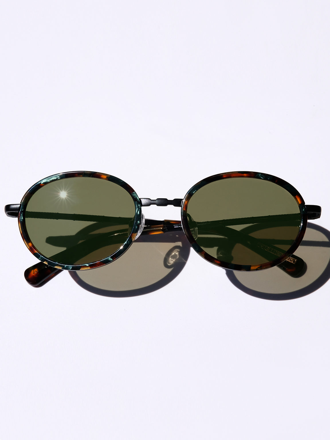 MATTE BLACK CLASSIC UNISEX OVAL SUNGLASSES, MATTE BLACK METAL DETAILS. OLIVE GREEN LENS. ART DECO DESIGN, LIMITED EDITION. DESIGNER EYEWEAR, LUXURY SUNGLASSES. CELEBRITY SUNGLASSES. FEMALE ENTREPRENEUR.